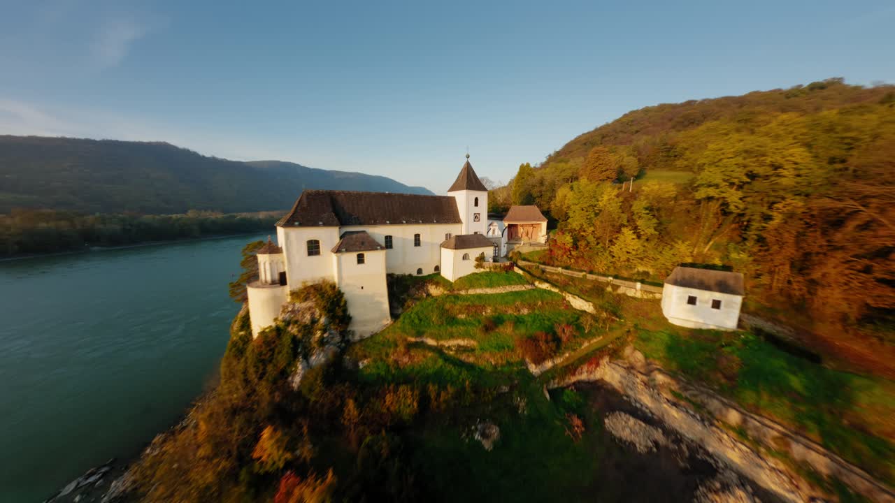 Slow ascending aerial round shot of stunning monastery Schönbühel in autumn light