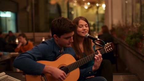 couple performing live music on the street