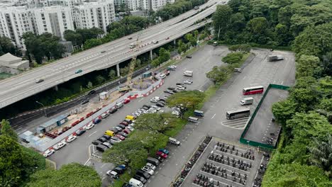 gliding above west coast highway and a car park in singapore - aerial drone shot