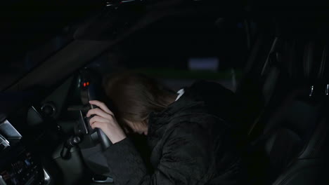 Exhausted-sad-woman-girl-in-car-parked-at-side-of-busy-road