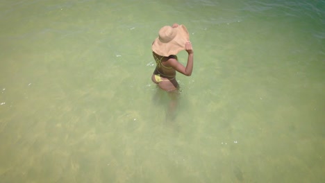 A-woman-in-a-yellow-bikini-and-straw-hat-radiates-beauty-on-her-vacation