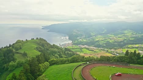 aerial panoramic view from pico dos bodes viewpoint on lush hilltop to atlantic ocean, são miguel island