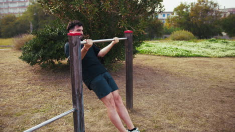 effort of an athlete training his arms outdoors at the park