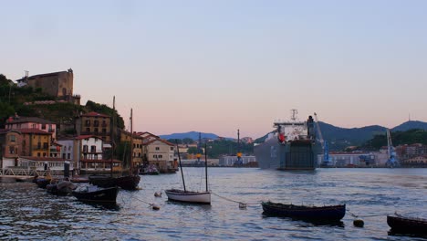 Big-Cargo-Ship,-Vehicle-Carrier-entering-the-bay-during-the-golden-hour