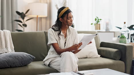 Woman,-calculator-and-budget-on-sofa-of-home