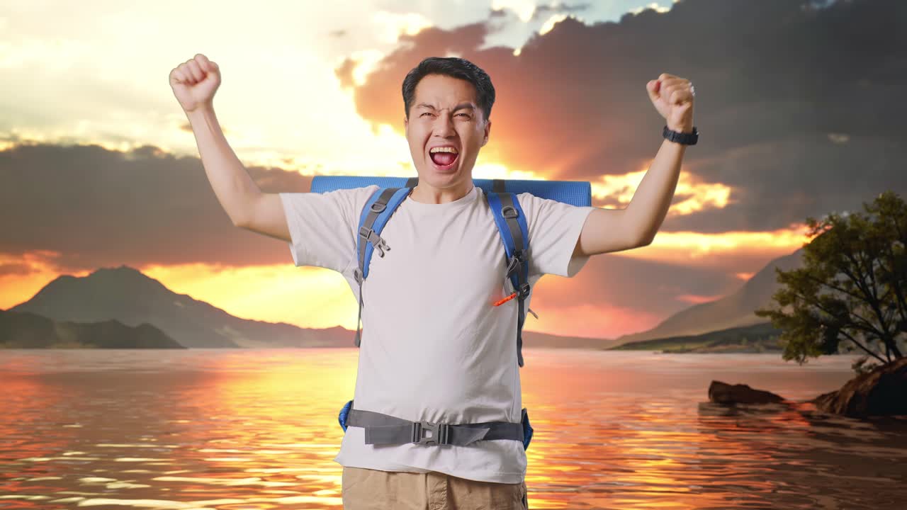 Asian Male Hiker With Mountaineering Backpack Screaming Goal Celebrating The Success At A Lake