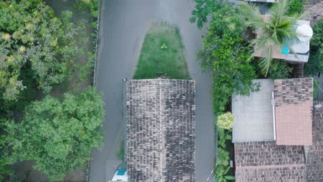 aerial top-down drone view of rural beach town caraiva bahia brazil flying over rooftops and church