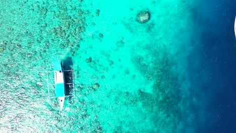 abstract tropical sea summer vacation background, turquoise waters of the caribbean sea with the small fishing boats, high angle