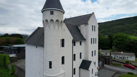 Crane-shot-of-white-fronted-Old-Barracks-reveals-rural-town-of-Cahersiveen-in-Ireland