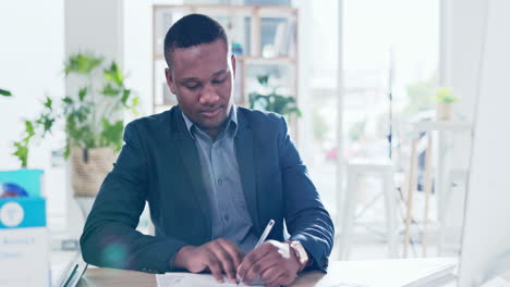 Black man, writing and computer in office
