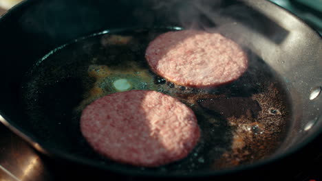 preparation for hamburger on hot frying pan. fast food worker preparing food