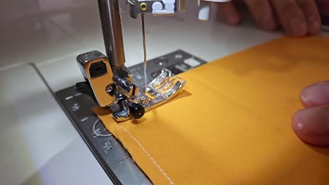 patchwork quilt creation process - closeup of the sewing needle in slow motion