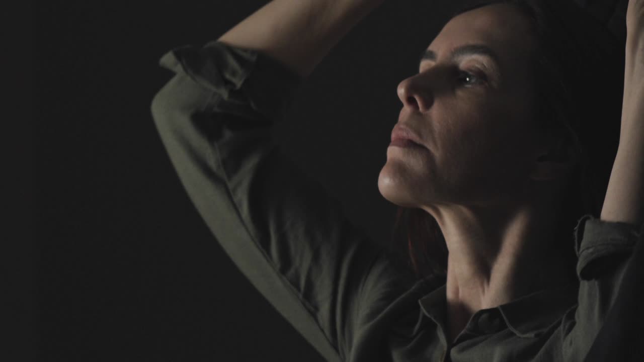 A Muslim woman gets up early - puts on a hijab headscarf in the darkness