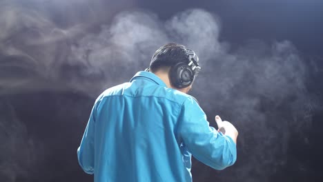 man dancing with headphones on at night club