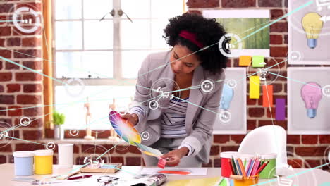 Animation of network of connections with icons over african american businesswoman