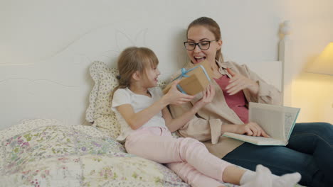 mother and daughter sharing a gift