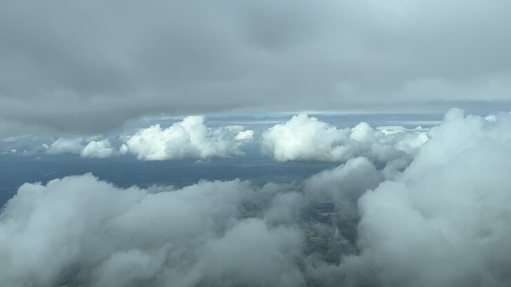 Flying across a partially cloudy sky with some tiny white clouds