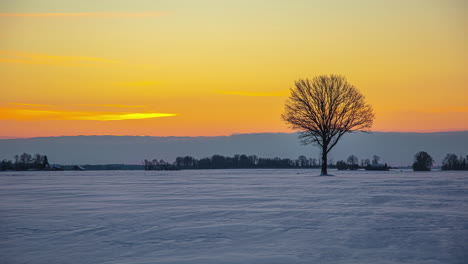 beautiful sunset sky through frozen field, moving clouds at the background, timelapse