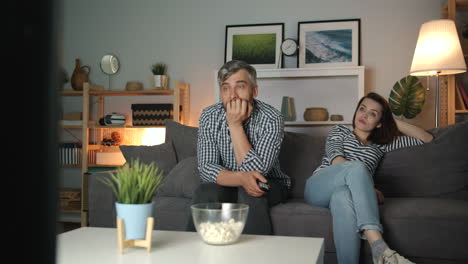 couple watching disappointing tv