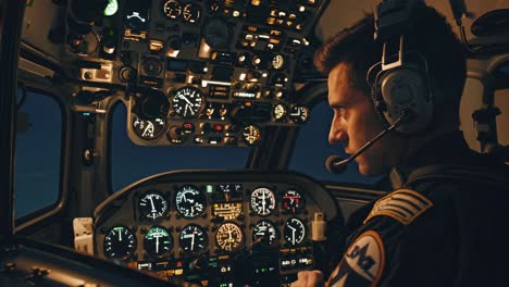 pilot in helicopter cockpit at night