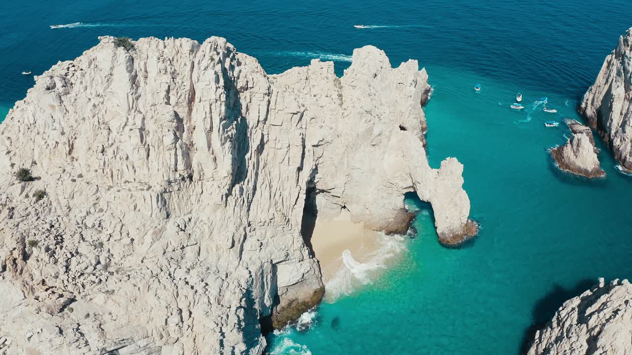 Incredibly gorgeous aerial drone panoramic of a exotic rocky cliff faces amidst striking blue aqua ocean water