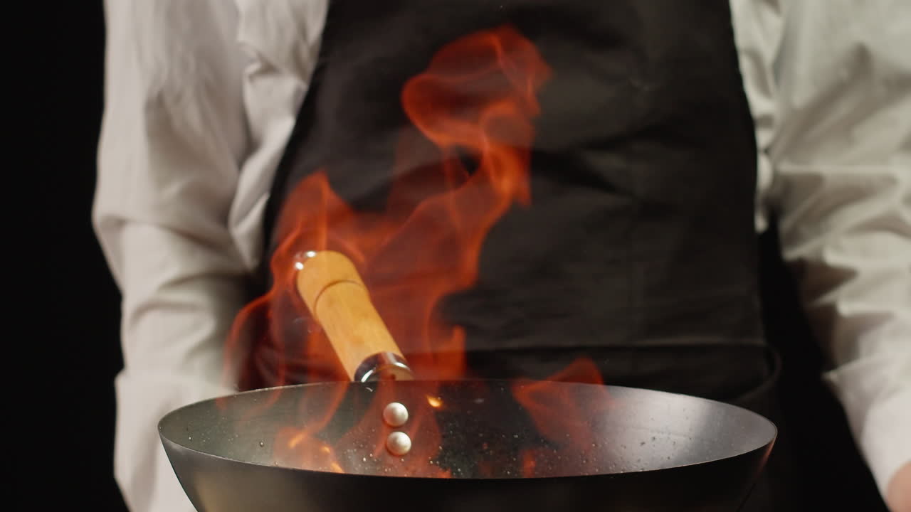 Chef Cooking in Wok with Fire