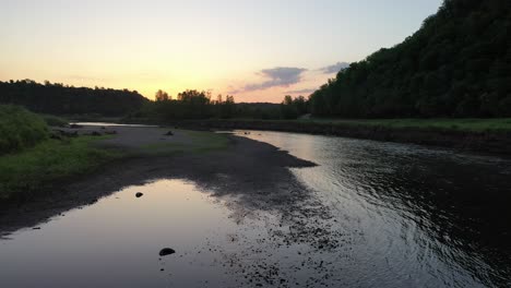 sunset over a river in a forest