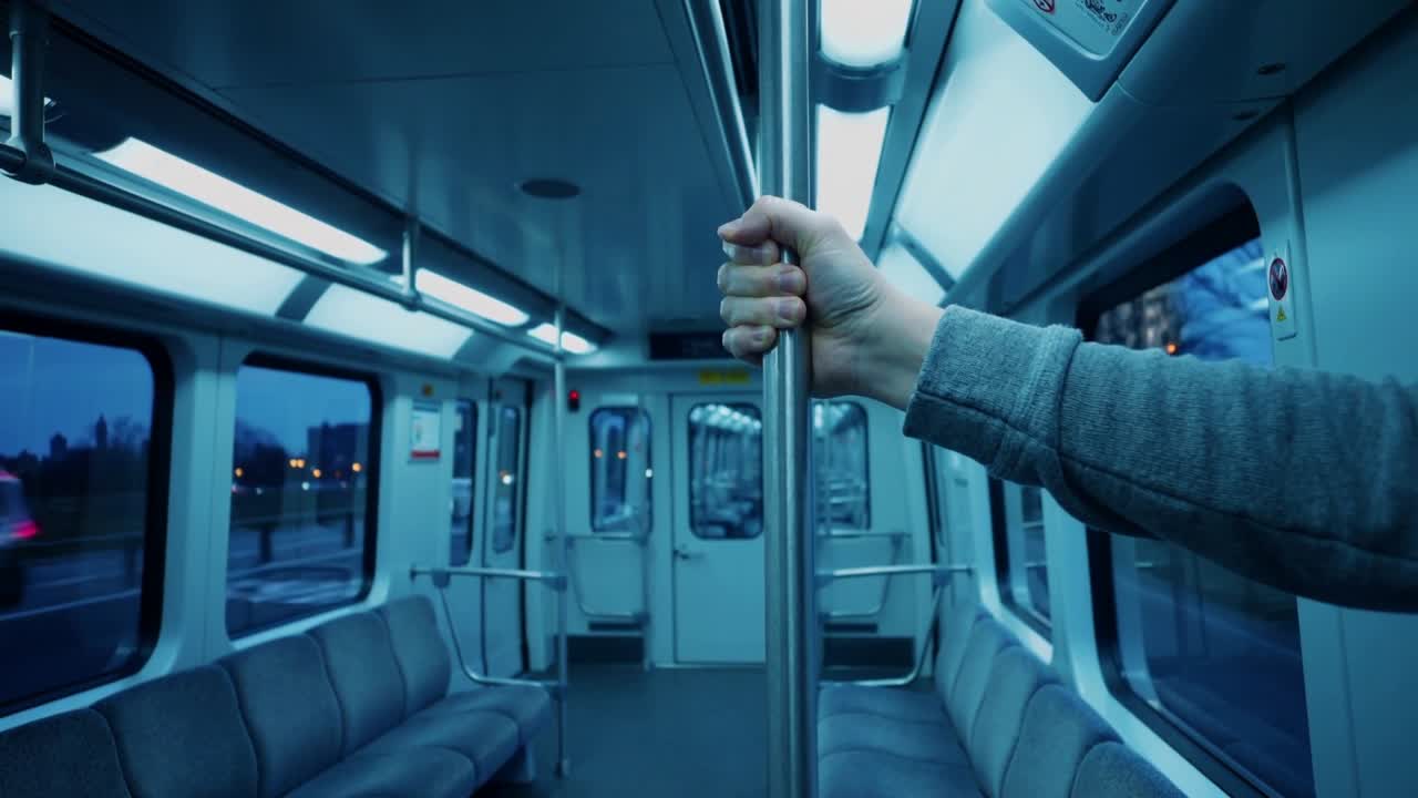 Vehicle moving causing adult right hand adjusting grip on stainless pole in light rail, copy space