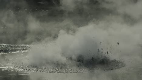 boiling hot geothermal volcanic mud pool, closeup shot steamy lake bubbling mud