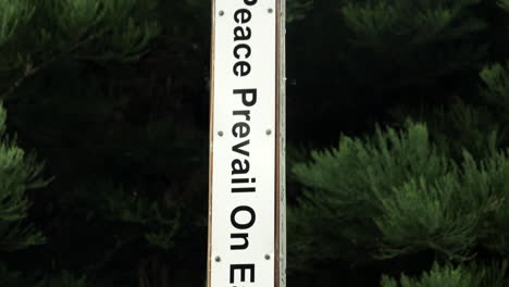 may peace prevail on earth vertical black and white sign