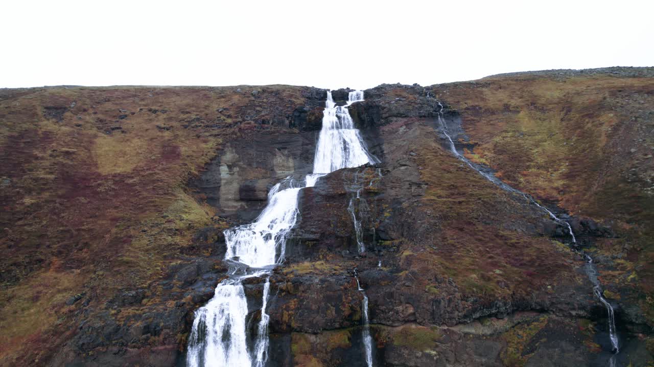 Aerial: Crane shot descending Rjukandafoss waterfall, a hidden treasure amidst Iceland's pristine wilderness