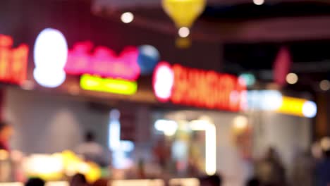 out-of-focus lights and people in a shopping center