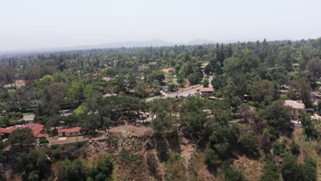 low aerial dolly shot of burned and surviving homes along eaton canyon after the fires in altadena, california. 4k