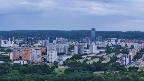 residential district in gdansk, poland, showcasing numerous buildings, green spaces, and a cloudy sky, offering a comprehensive perspective of urban and natural environments , drone realing shot