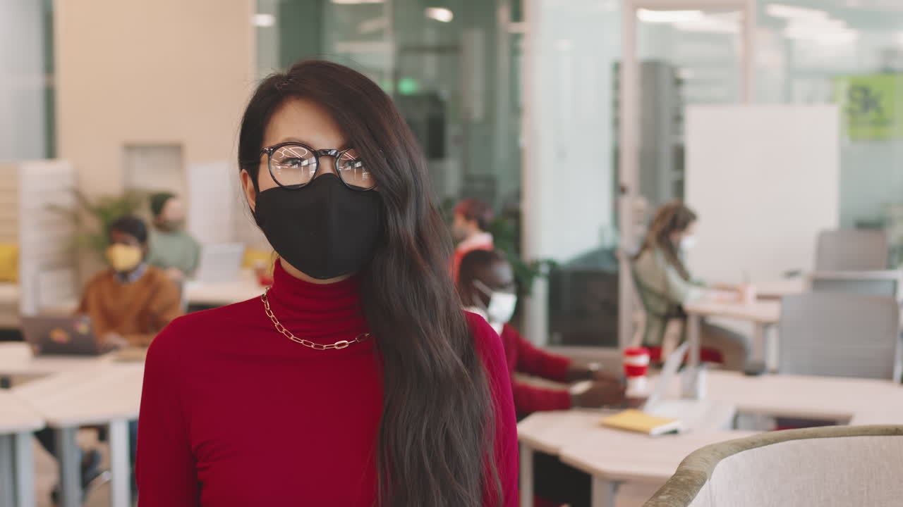 Young Businesswoman in Face Mask Posing in Workplace