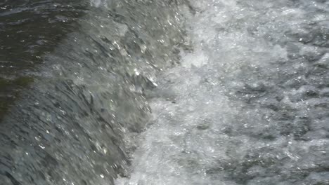 water stream running down the slope, rapid water motion waterfall