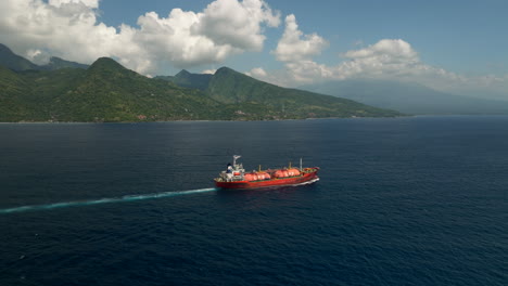 Red-tanker-transporting-petroleum-in-ocean-near-Bali-North-Coast,-aerial-view