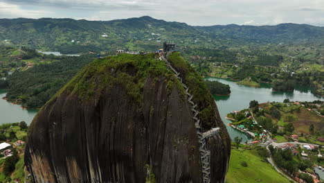 aerial view around the stairs up to the el peñón de guatapé, in cloudy colombia