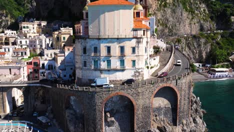 Drone-Descends-to-Reveal-Cars-Driving-along-Amalfi-Drive-Coast