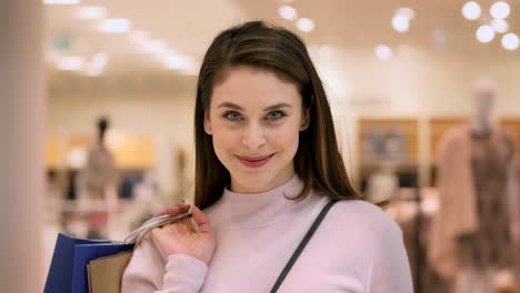 Portrait-of-joyful-woman-with-full-shopping-bags