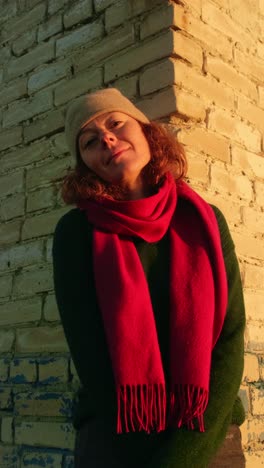 woman by a brick wall at sunset
