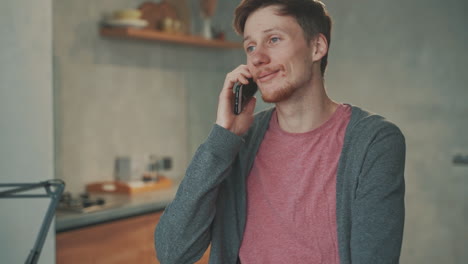 young male teleworking from home, having a call