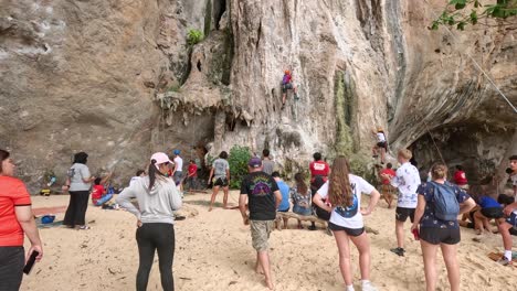 group of kids climbing limestone rocks in krabi