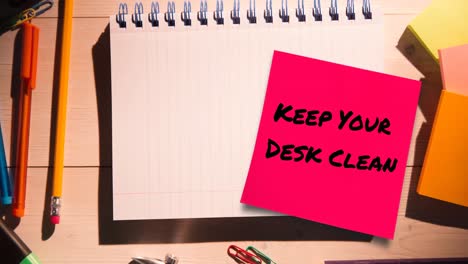 Animation-of-keep-your-desk-clean-text-on-memo-note-over-notebook-on-desk