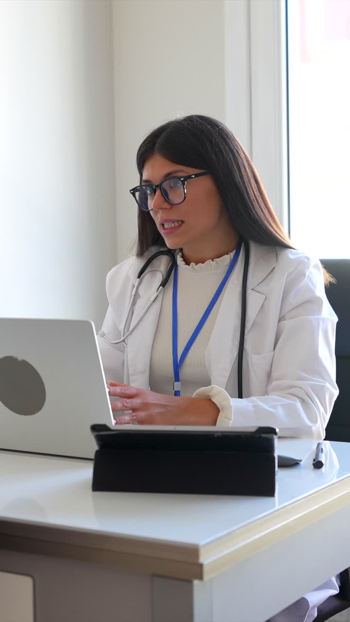 Doctor working on a laptop in her office