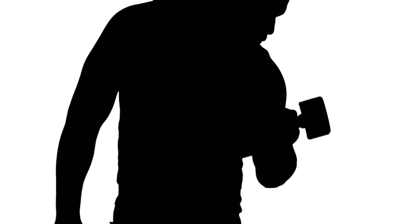 Muscular silhouette of man lifting dumbbels