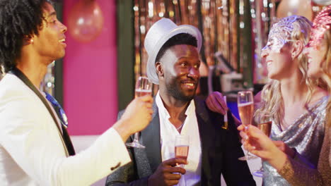 video of happy diverse group of friends making a toast with glasses of champagne at a nightclub