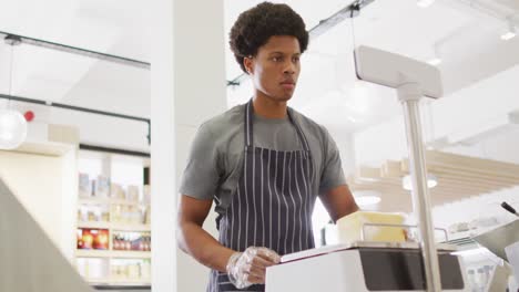 Animation-of-focused-biracial-waiter-weighting-cheese