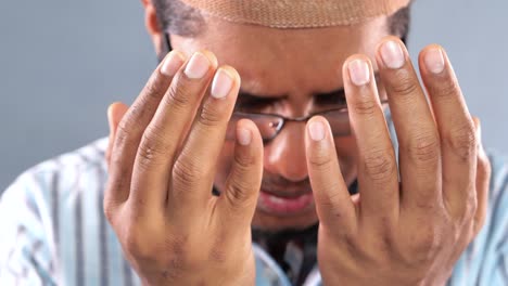 muslim man praying during ramadan, close up