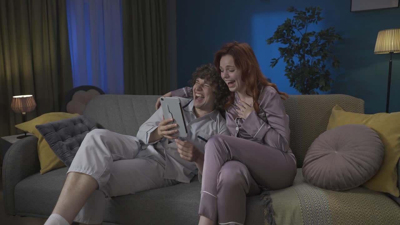 Couple enjoying a video call on a tablet at home